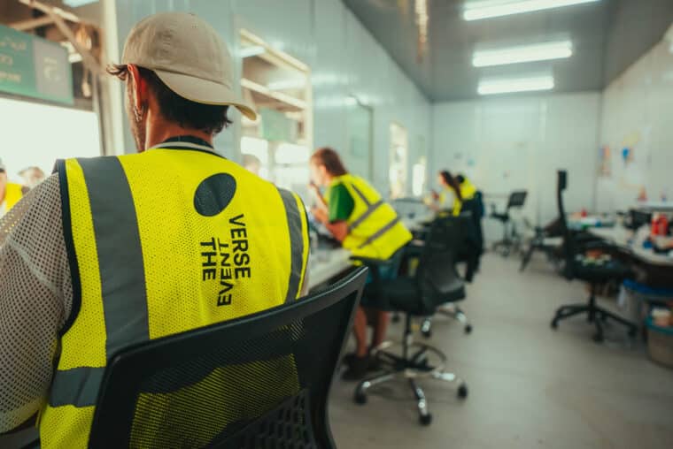 Event Verse crew in branded high-vis vests at a production desk